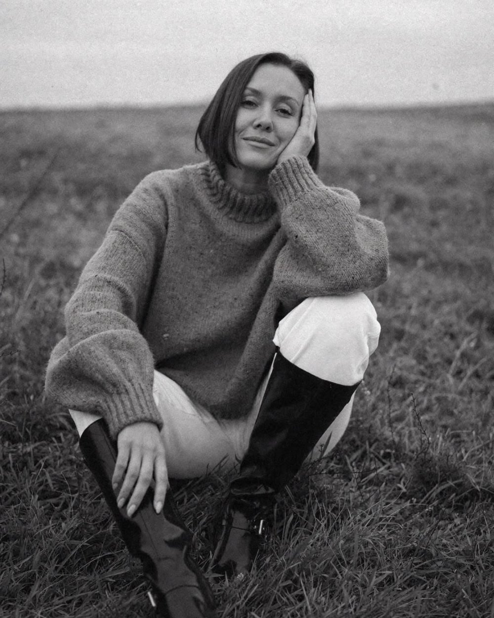 Emma Armstrong, The Naked Doula, sitting in a field